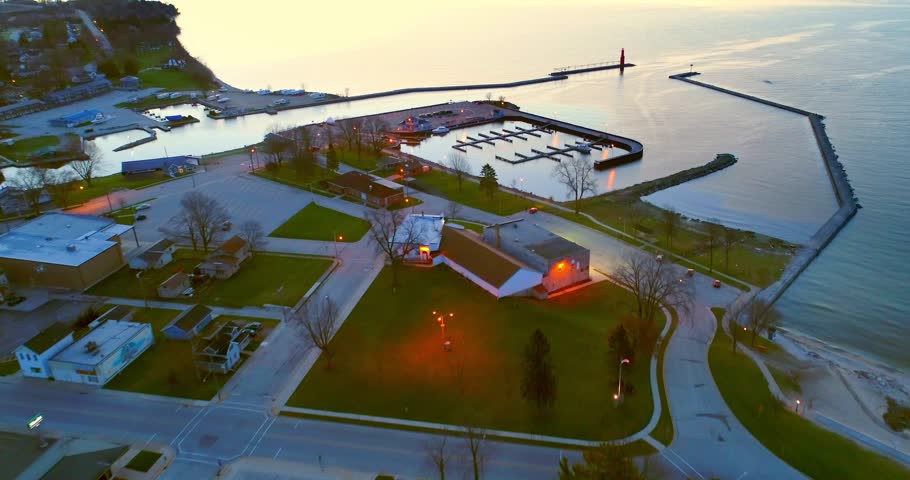 Algoma Wisconsin harbor and Lighthouse in vast Lake Michigan before Sunrise, aerial view.