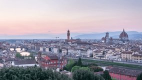 Panoramic view of Florence, Italy. City skyline. Day to night transition. Time lapse video. City lights switch on. Purple, sunset sky.