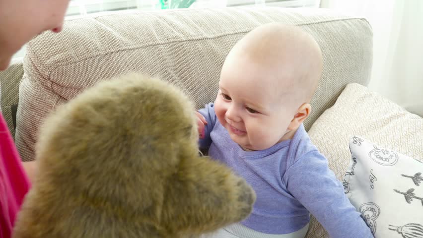 Mother playing with 6 months son