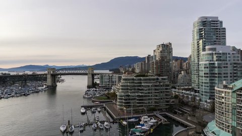 Aerial Timelapse of a cloudy sunset at False Creek, Downtown Vancouver, British Columbia, Canada.