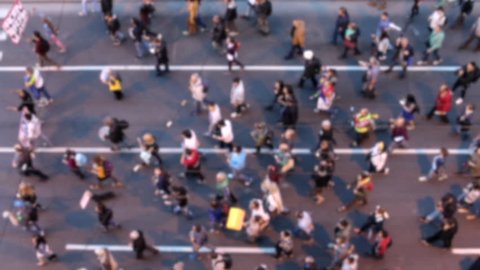 Top view of people walking. Crowd of people on street. Citylife concept. Defocused footage.