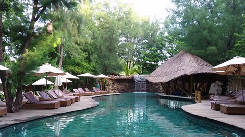 LOMBOK, INDONESIA - APRIL 10, 2017: Modern swimming pool in the garden with 4K resolution view.