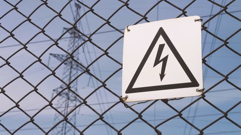 Power substation. Warning sign about the risk of electric shock. High-voltage wires on the support, production and transportation of electricity. life threatening. dangerous.