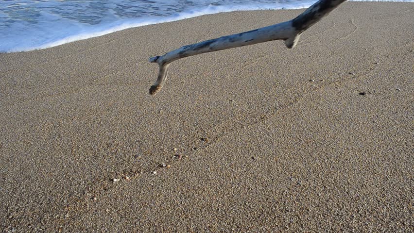 The word the sos on sand.  Shooting on the sea beach.