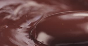 Slow motion of premium dark melted chocolate pour toned video, 4k 60fps prores footage