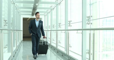 Businessman walking through airport terminal