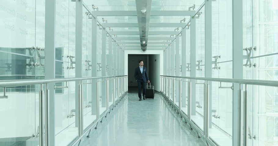Businessman walking through airport terminal
