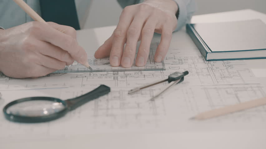 Frellance architect sketching a construction project with pencil and ruler at work place. | Shutterstock HD Video #26354156