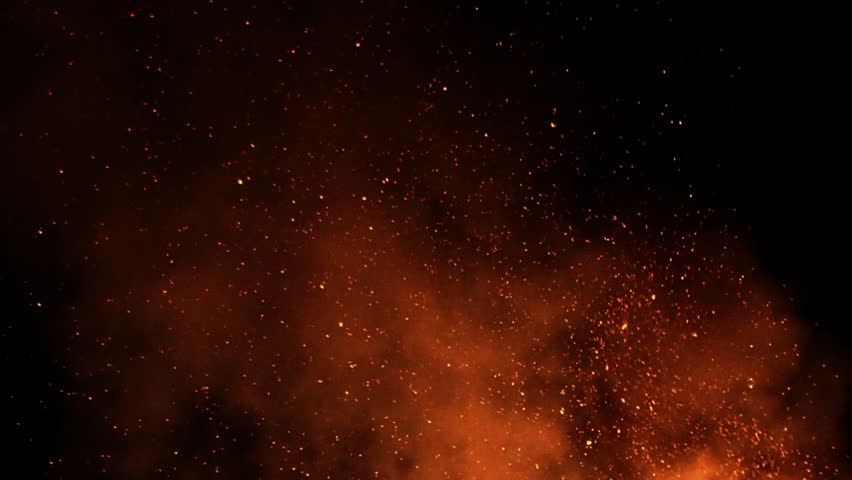 Burning ash rise from large fire in the night sky - slow motion