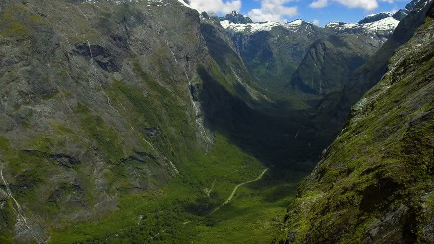 Aerial Landscape of New Zealand Fiordland near Milford Sound, Fiordland National Park, New Zealand. Waterfall on mountains, valley river near Milford Sound, New Zealand.