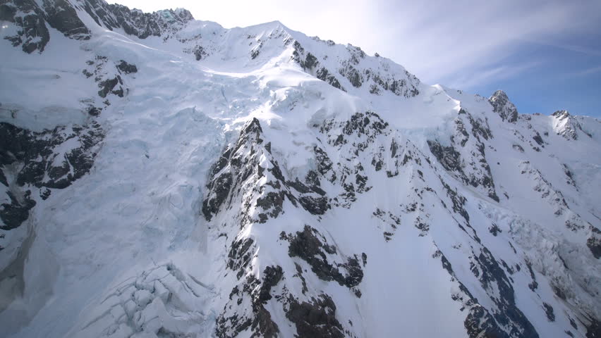 Snow capped peak in Mt Cook National Park, New Zealand from aerial view, helicopeter windows. Royalty-Free Stock Footage #26366585