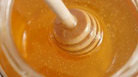 Taking dipper from sweet food substance slow-mo 1920X1080 HD footage - Wooden utensil in glass honey jar slow motion 1080p FullHD video
