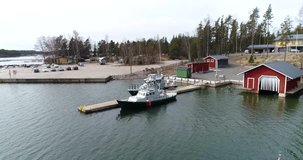 SKALDO, UUSIMAA, FINLAND - APRIL 11: Cinema 4k aerial around lifeguard boats at baggö harbor, in the finnish archipelago at Skaldo, just outside tammisaari national park, in Finland