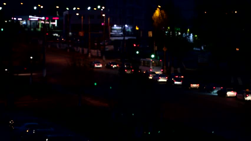 Image of the blurry light of automobile headlights on a road in a large city