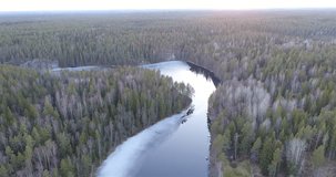 Haukkalampi, Cinema 4k aerial flight above haukkalampi pond, in nuuksio national park, on a sunny spring day, in Espoo, Finland