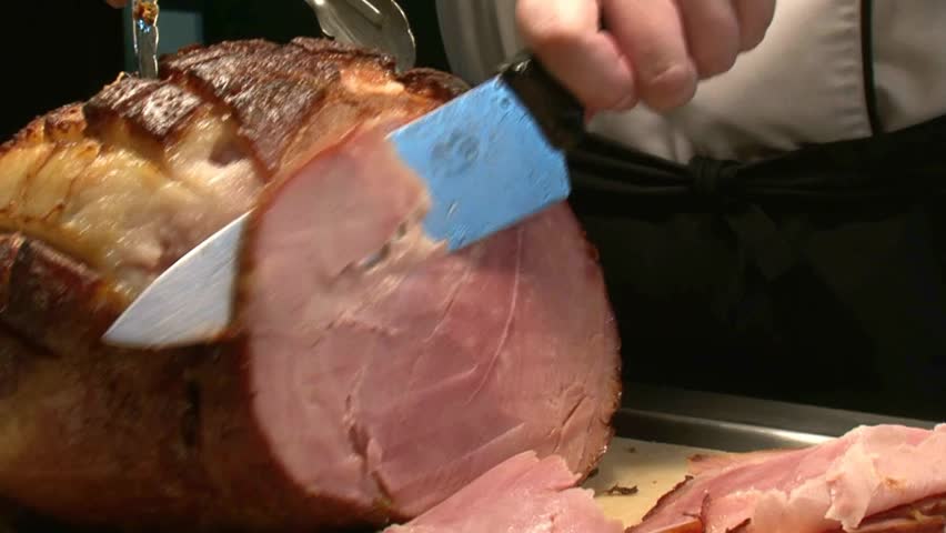 Chef carving slices of Ham in hotel restaurant