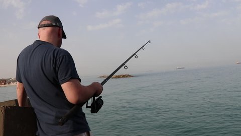 ASHKELON - ISRAEL, APRIL 2017: Fishing using fishing rod at sea
