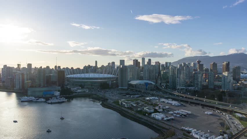 Aerial Timelapse of Downtown Vancouver colorful sunset. Taken in False Creek, British Columbia, Canada.
