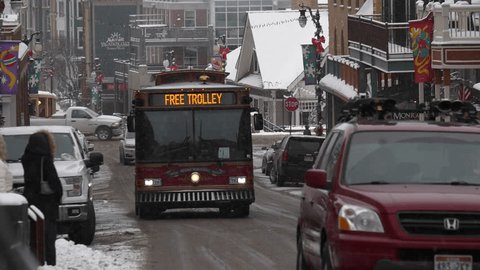 Park City, Utah, United States – February 2017.  Trolley drives on Historic Main Street in Park City, Utah during a winter snow storm.
