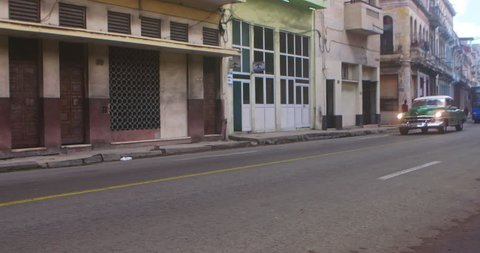 Street Scene & vintage taxi car In slow motion Havana, Cuba