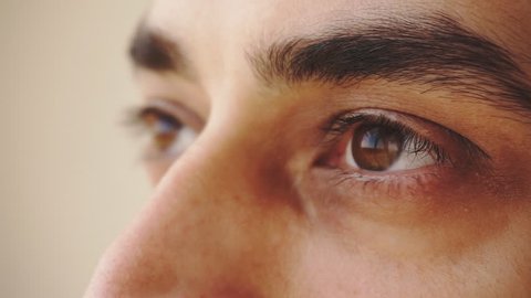 Close up of man's brown eyes looking upward