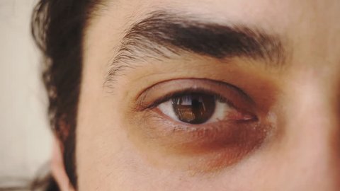 Close up of man's brown eyes looking into camera 