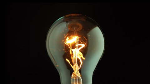 Real light bulb flickering. Incandescence thread with rotating, Macro shot
