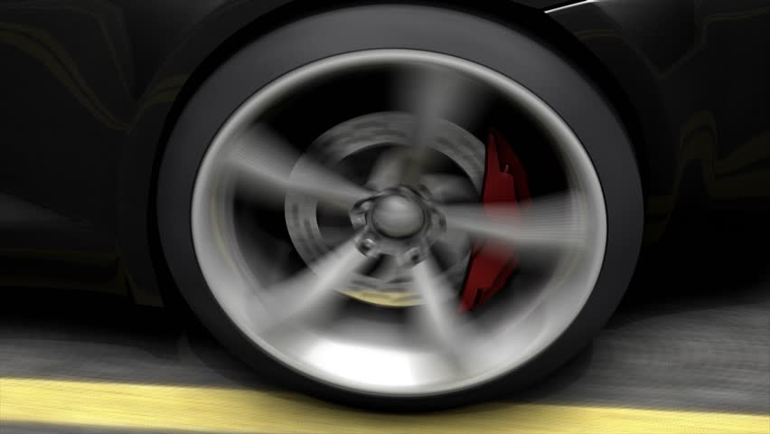Close-up spinning car rear wheel.