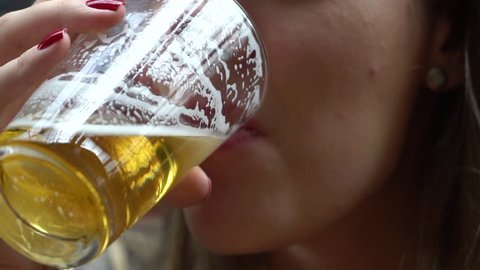 Closeup of Woman drinking Beer