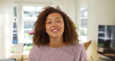 Happy laughing mixed-race millennial woman talking over video chat conference call. Cheerful African-American and Caucasian multi-ethnic girl using skype on computer in apartment. 4k