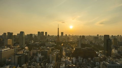 4k time lapse of night to day sunrise scene at Tokyo city skyline with Tokyo Tower. Tilt down