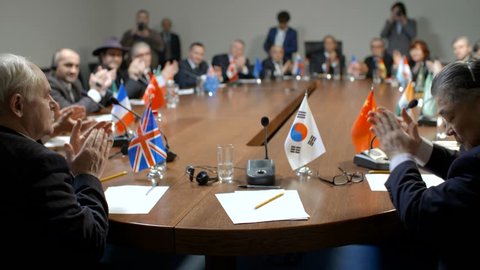 South Korea delegate at the round table during multinational pilitical debates or negotiations.