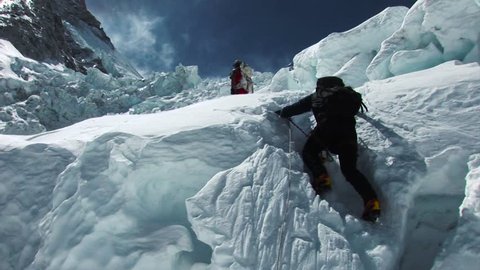 Hikers and sherpas climb/trek their way to the summit of Mount Everest, Himalayas, Nepal.  