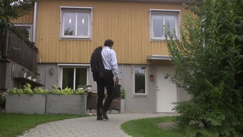 Man walking towards a house