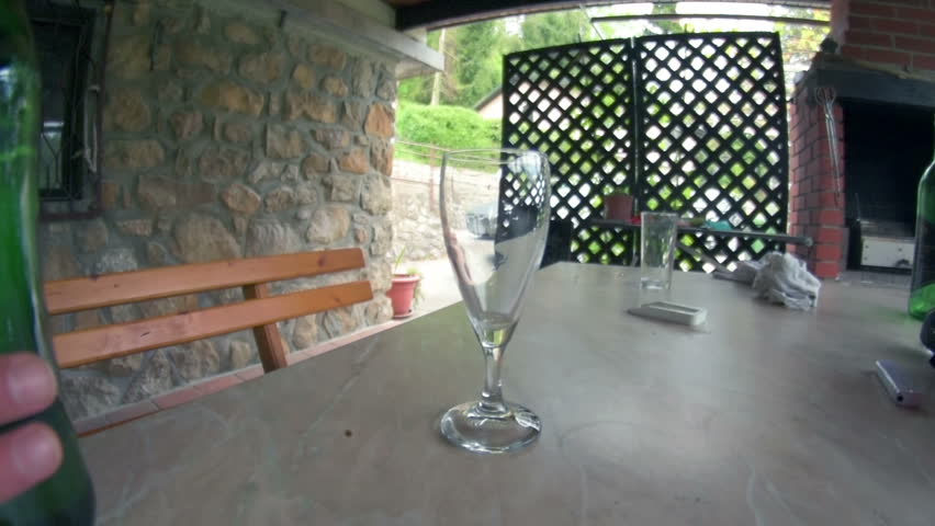 Pouring white wine into glass 