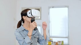 Thrilled Woman play game with virtual reality device at home