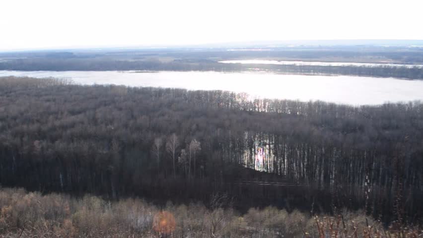 embankment of the river. in the spring flood period, flooded trees in the distance
