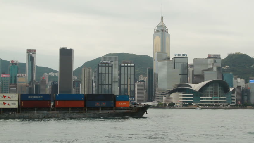 HONG KONG - MARCH 25: Container ship crossing the Victoria habour and city