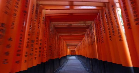POINT OF VIEW: Walking inside Fushimi Inari Shrine or Fushimi Inari Taisha, a Shinto shrine in Kyoto, Japan. A Japanese monument, famous for its thousands of vermilion torii gates. 