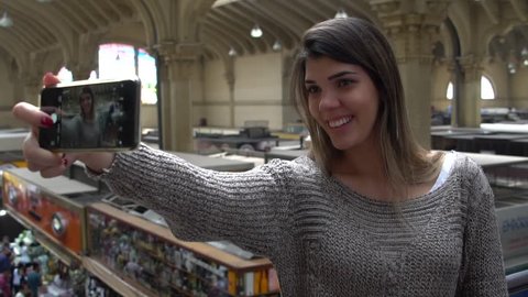 Woman taking a selfie in Municipal Market - Mercadao - in Sao Paulo, Brazil