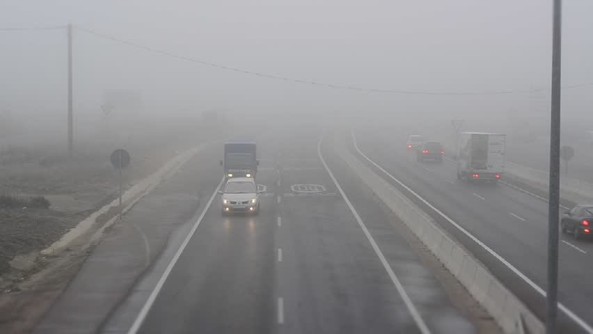 LEON, SPAIN - CIRCA 2012: Time lapse of cars driving in dense fog circa 2012 in