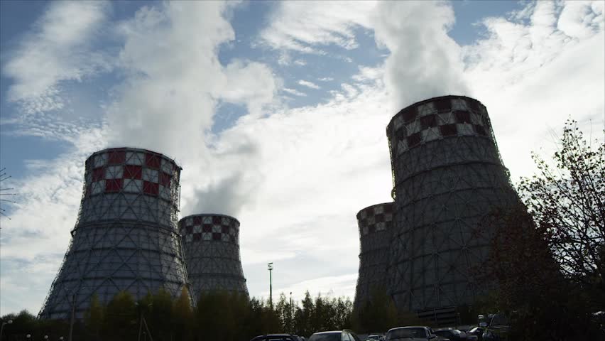 Fuming factory chimneys under the blue sky

