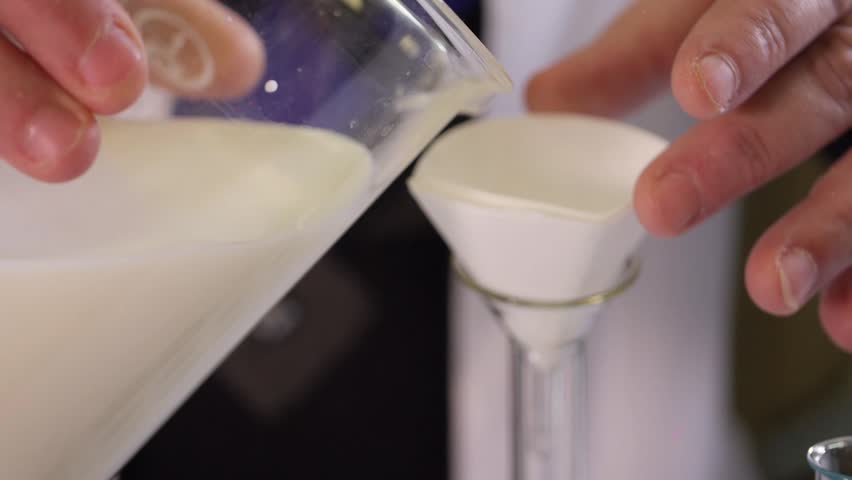 Laboratory assistant examines dairy products Royalty-Free Stock Footage #26457296