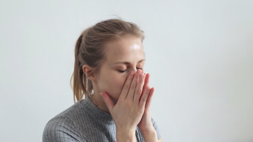 Woman rubs her eyes
