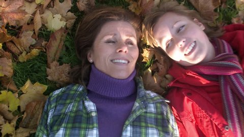 Mother, daughter and autumn leaves