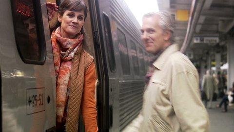 A man and a woman at a train station