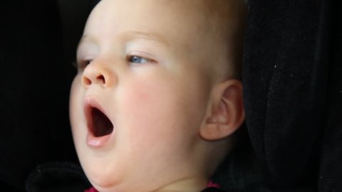 Tired Baby Yawns in Car Seat