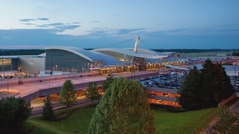 Raleigh-Durham International RDU Airport Terminal Building Exterior Timelapse with Aircraft and Vehicle Traffic Movement during Sunset into Evening