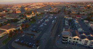 Aerial bird view drone footage of Namibian Atlantic coastal town Swakopmund, historical buildings architecture, town center and townscape with desert background at Namibia's west coast