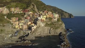 Aerial video footage with drone on Manarola , one of the famous Cinqueterre country, small village with colored houses on the cliff over the sea